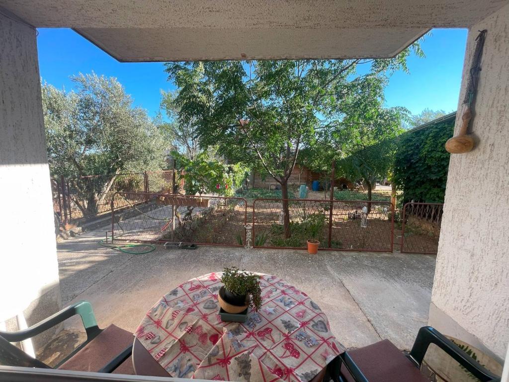 a table with a potted plant on a patio at Apartments Tonci in Zaton