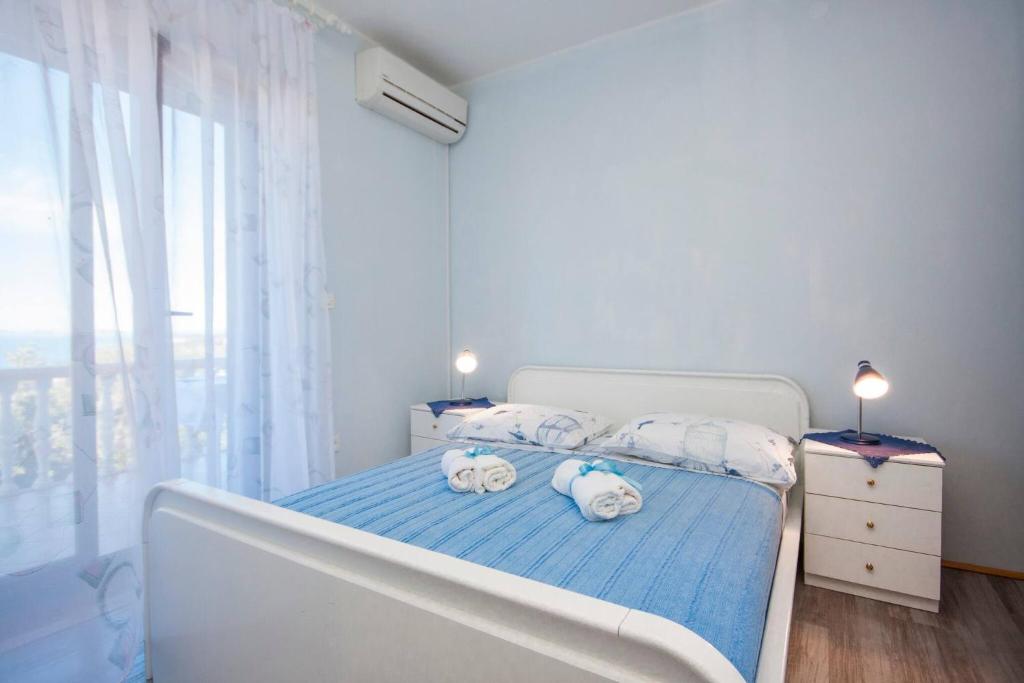 Postel nebo postele na pokoji v ubytování Family Apartments & Rooms Mikelin