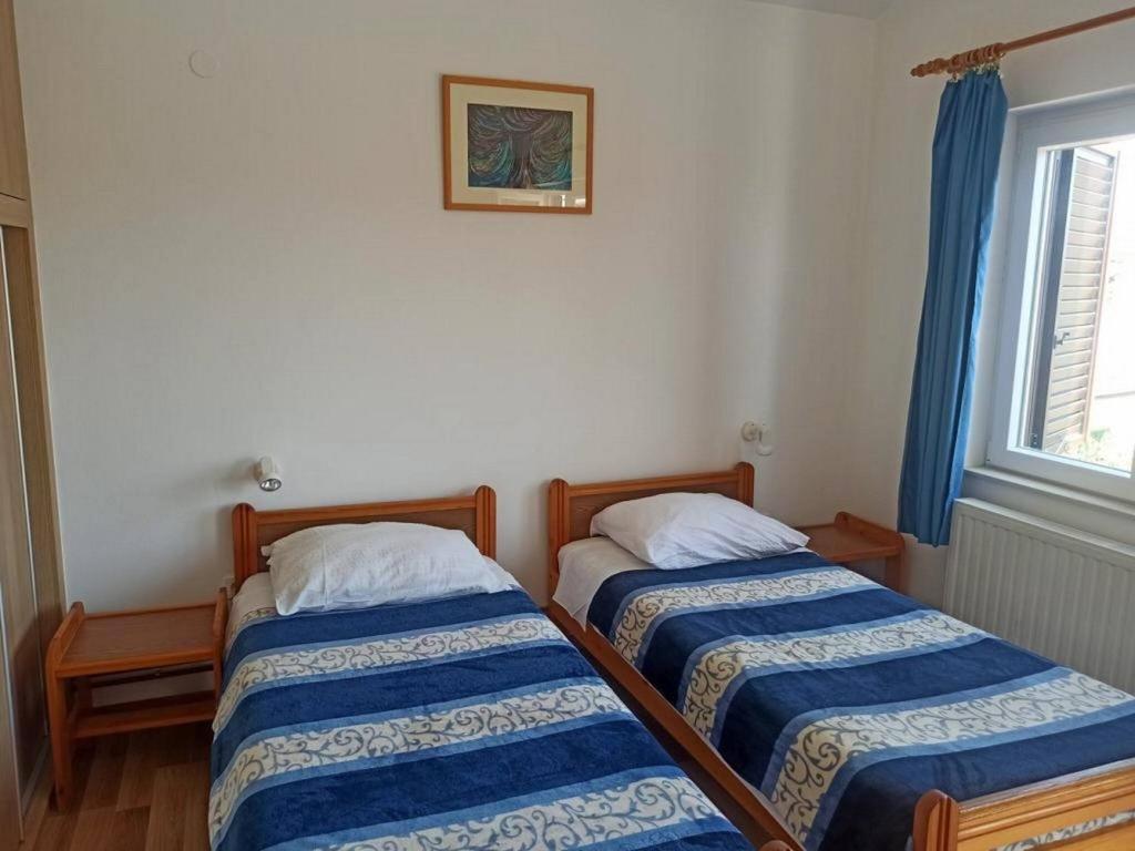 Postel nebo postele na pokoji v ubytování Apartments Pletikosa Gaj