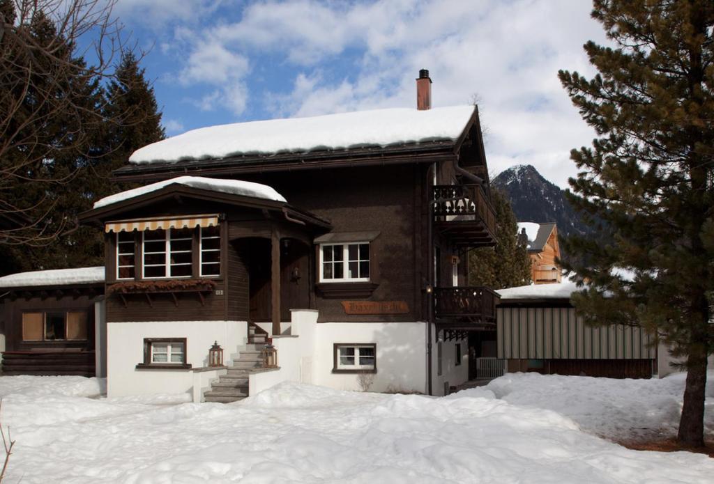 a house with snow on the front of it at Silverbirch Chalet - Davos in Davos