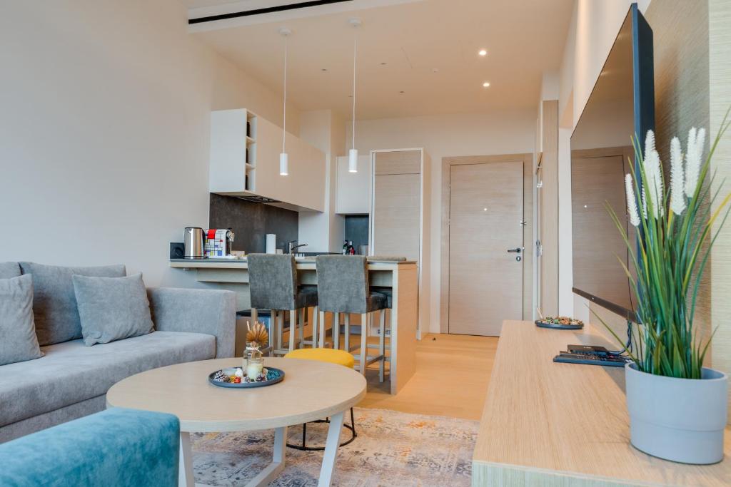 a living room with a couch and a table at ZEPTERME Luxury Apartments & Studios by CENTRAL in Vrnjačka Banja