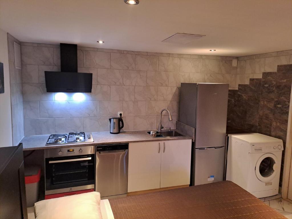 a kitchen with a refrigerator and a washer and dryer at Zana Apartments in Stari Grad