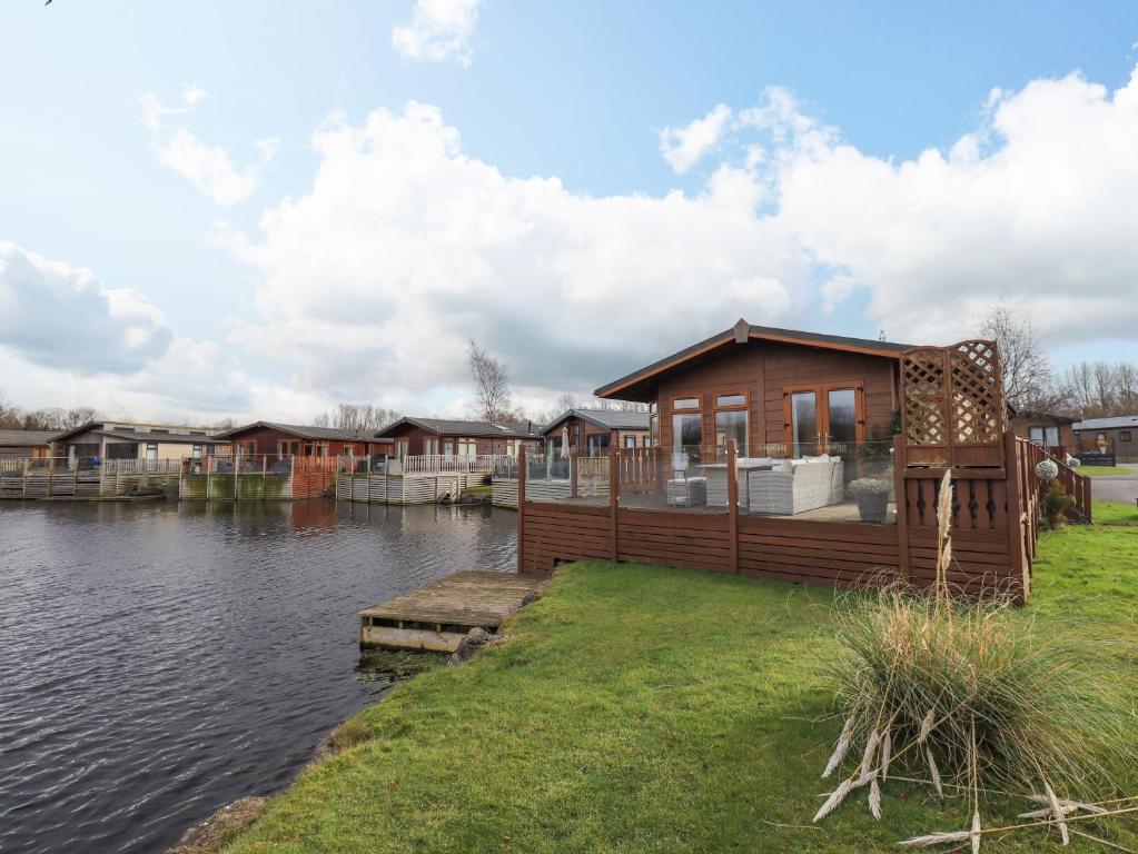 a small house on the side of a river at Otters Reach in Carnforth