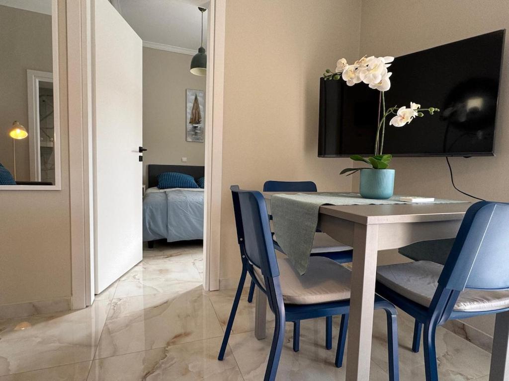 a dining room with a table and blue chairs at Cecilia's cozy apartment in Athens