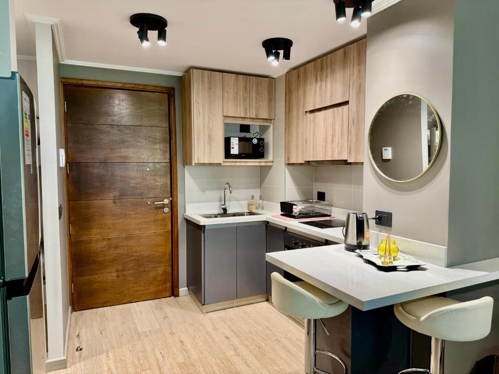 a kitchen with a counter and a sink and a door at Lago y Volcán in Pucón
