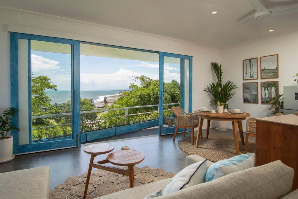 a living room with a view of the ocean at Ulus - Tropical 1 Bedroom Ocean View Apartment by Triang Villas in Tanah Lot