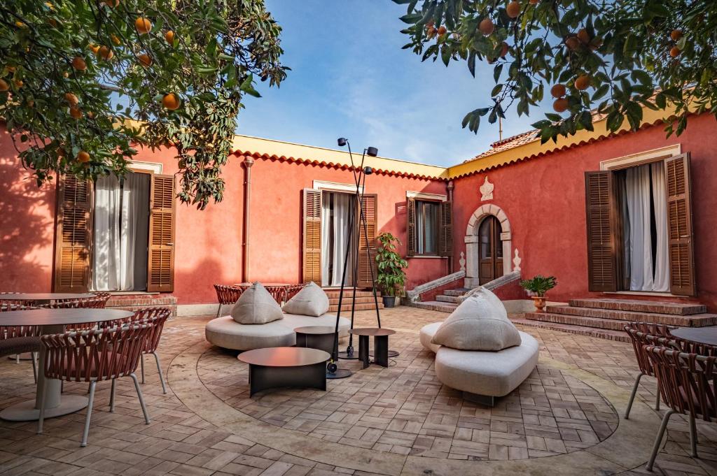 a patio with tables and chairs in front of a building at Villa Conrad in Taormina