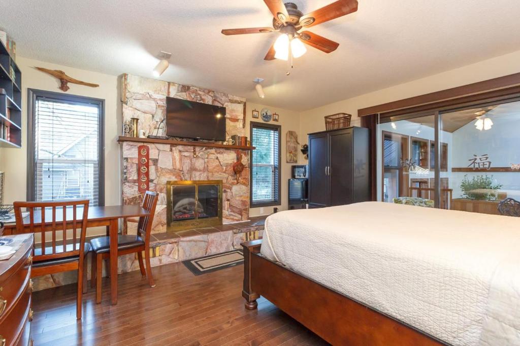 a bedroom with a bed and a fireplace at Cole's Bay Vacation Retreat Library Room in YYJ
