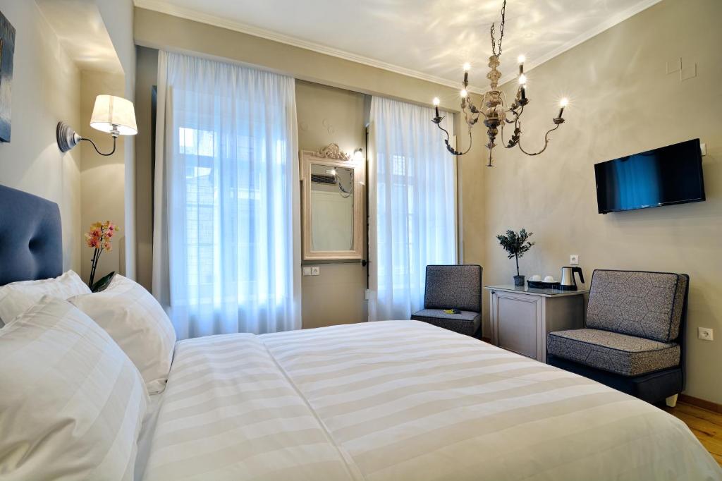 Posteľ alebo postele v izbe v ubytovaní Hotel Antique