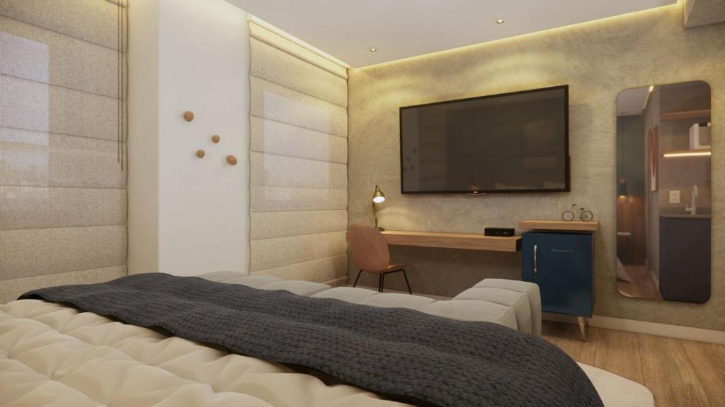 a bedroom with a large bed with a television on the wall at Cyclinn Jesuíno Arruda Itaim in São Paulo