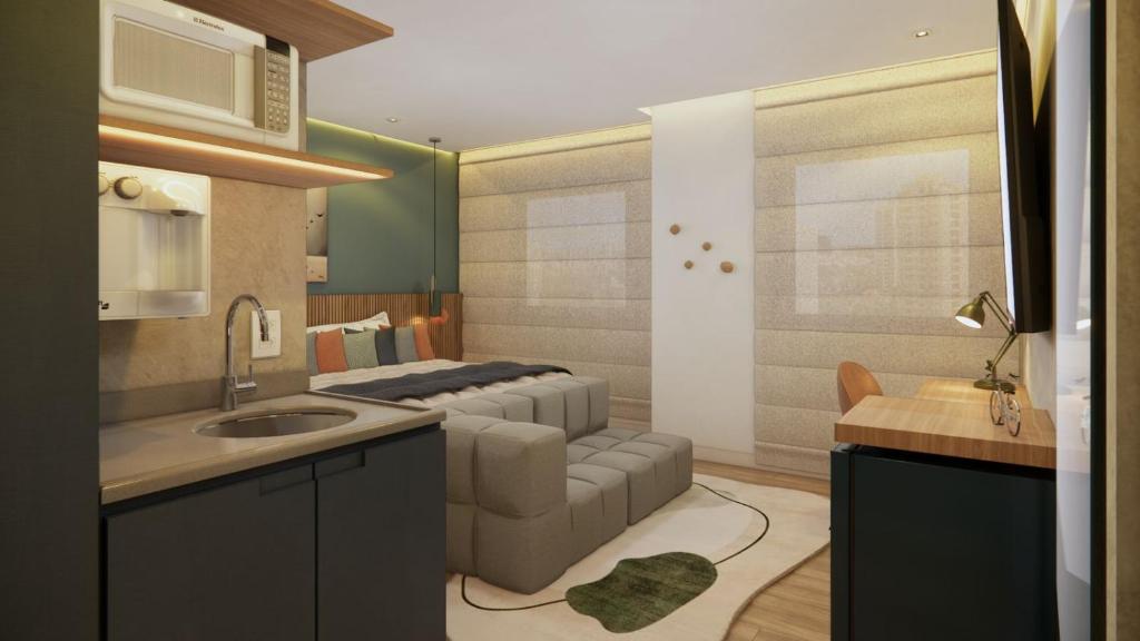 a kitchen with a couch and a living room at Cyclinn Jesuíno Arruda Itaim in São Paulo
