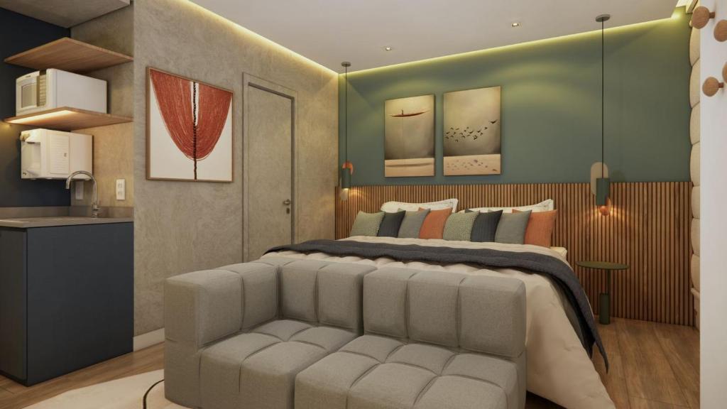 a bedroom with a large bed and a couch at Cyclinn Jesuíno Arruda Itaim in São Paulo