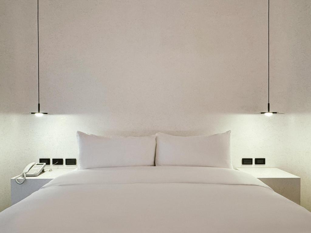 Postel nebo postele na pokoji v ubytování Hope Hotel Tainan - Kangle Branch