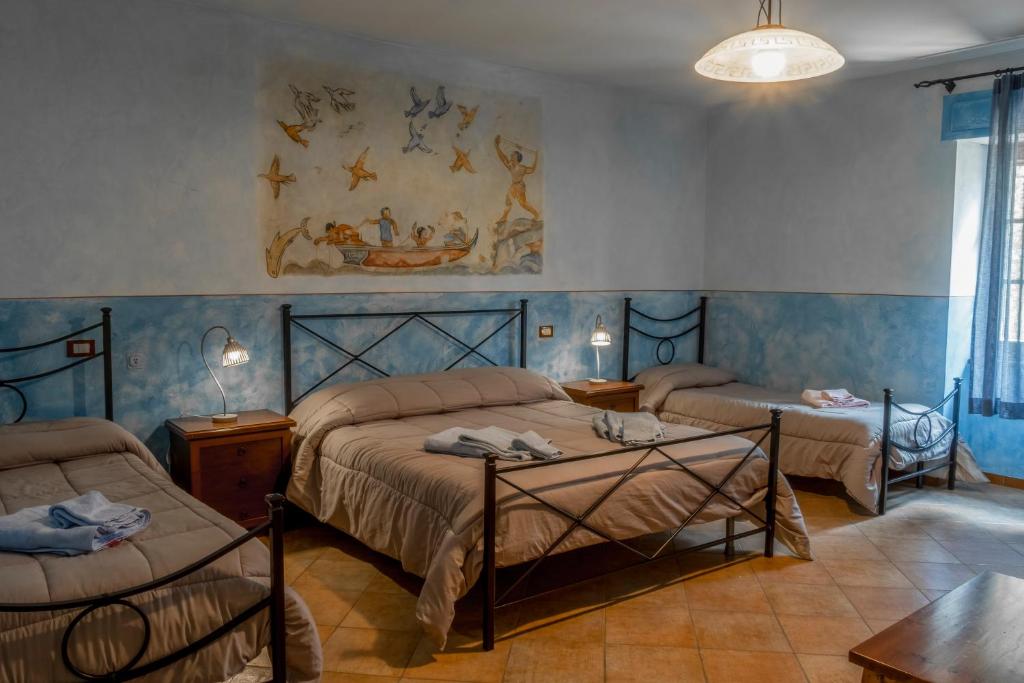 Postel nebo postele na pokoji v ubytování Bio Agriturismo Aia del Tufo