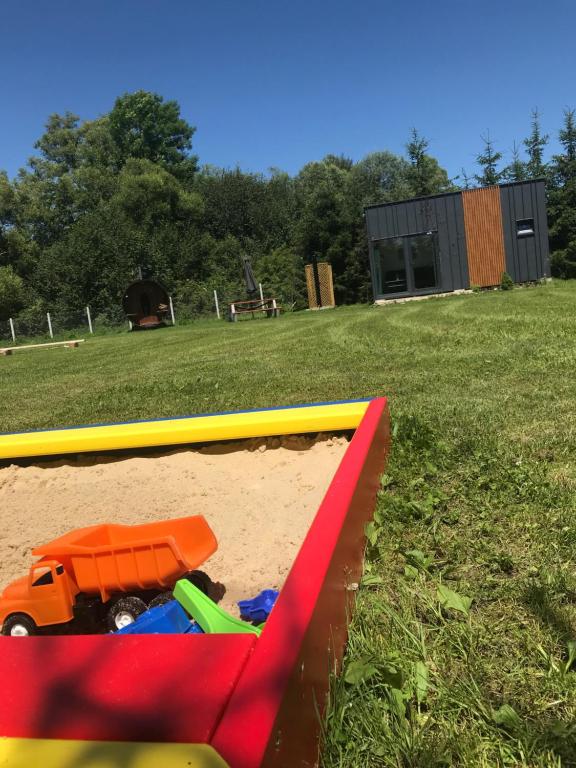 a toy truck in the sand in a sandbox at TinyHouses & Garden in Oravská Poruba