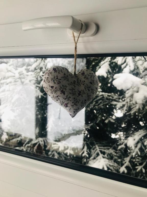 a heart hanging from a window of a car at TinyHouses & Garden in Oravská Poruba