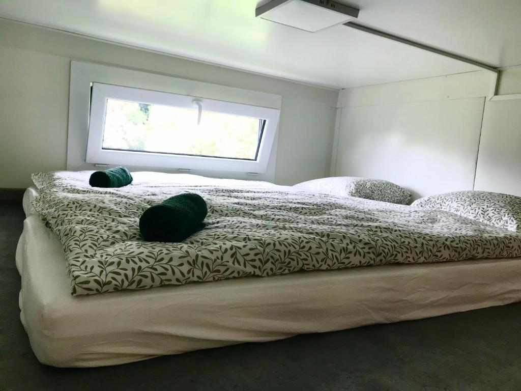 a bedroom with a large bed with two pillows on it at TinyHouses & Garden in Oravská Poruba