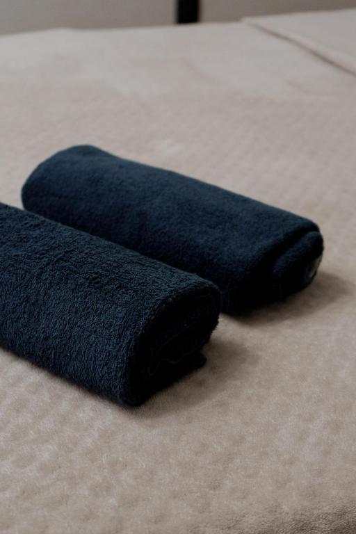 two blue towels sitting on top of a bed at Махаббат in Petropavlovsk