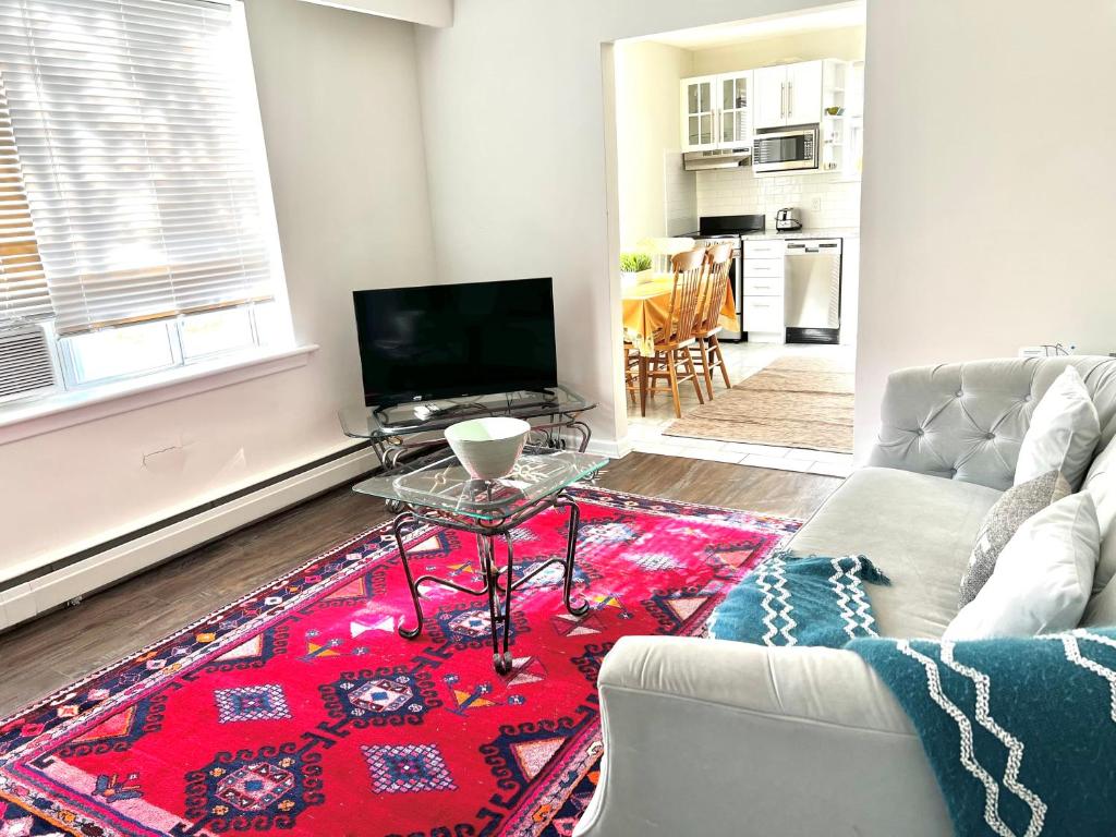 a living room with a couch and a table at Elegant Brand New Apartment in Central Burlington in Burlington
