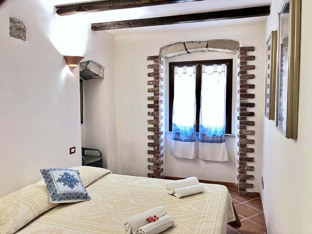 Ένα ή περισσότερα κρεβάτια σε δωμάτιο στο Spiaggia e borgo - la tua casa a Castelsardo