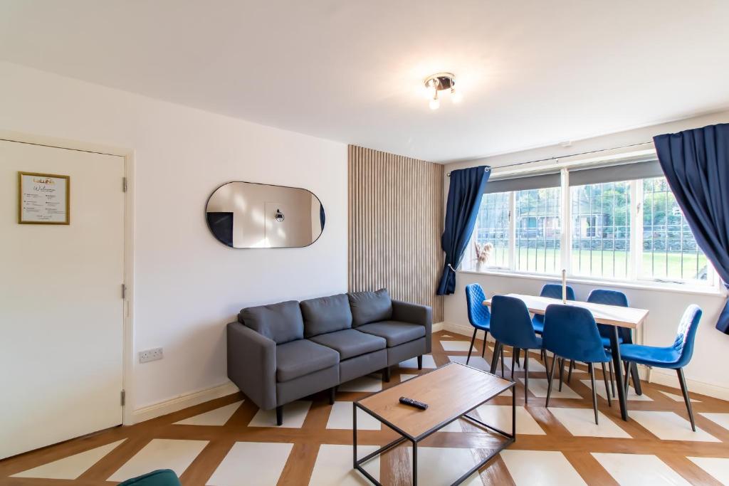 a living room with a couch and a table and chairs at Great offers on Long Stays!! LaLuNa Apartments in Gateshead