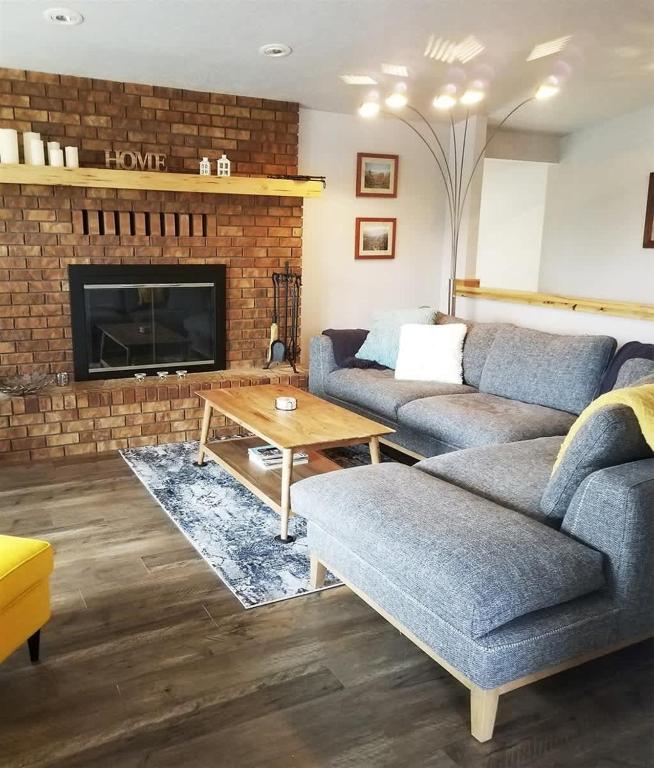 a living room with a couch and a fireplace at PA Sea View Deck House in Port Angeles