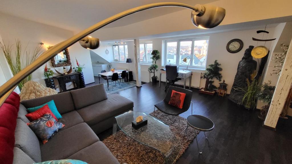 a living room with a couch and a table at Luxury Apt - View of the Center of Prague in Prague