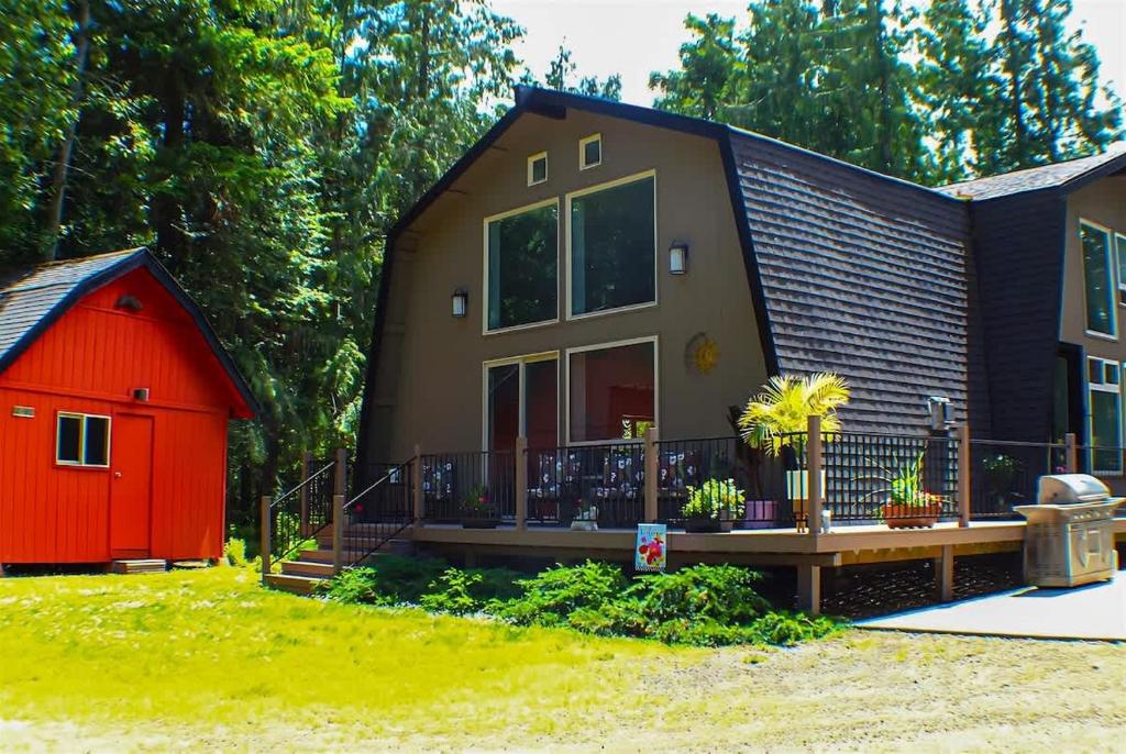 a small house with a red shed next to it at Sqe Mystic Grove in Sequim