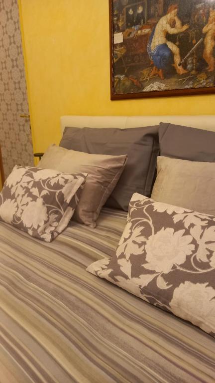 a bed with two pillows and a painting on the wall at Villa Mary in Venegono Superiore