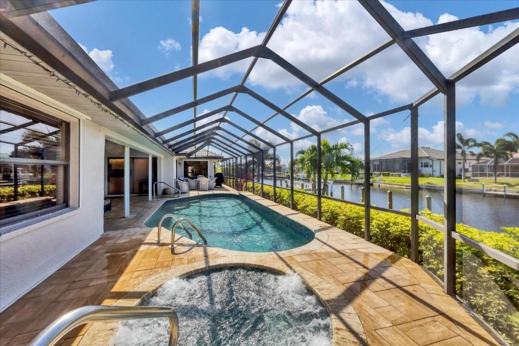 an indoor swimming pool in a house with a glass ceiling at LPC1140 in Punta Gorda