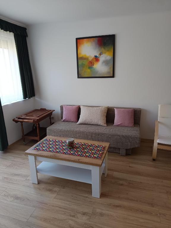 a living room with a couch and a table at City-Apartman in Kaposvár