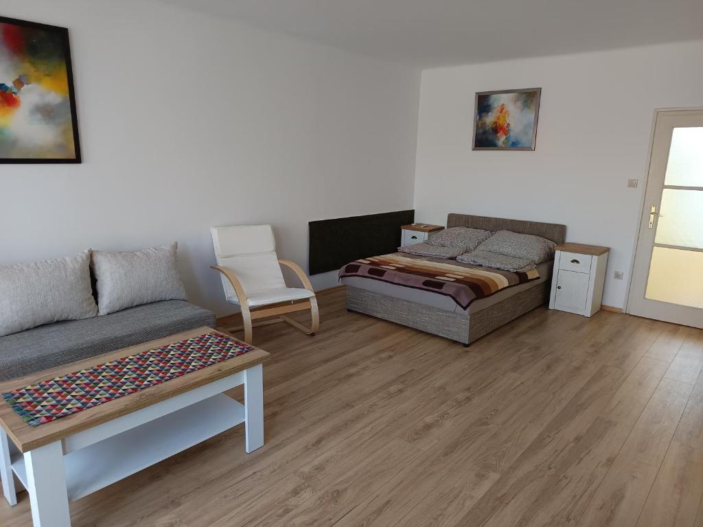 a living room with a bed and a couch at City-Apartman in Kaposvár