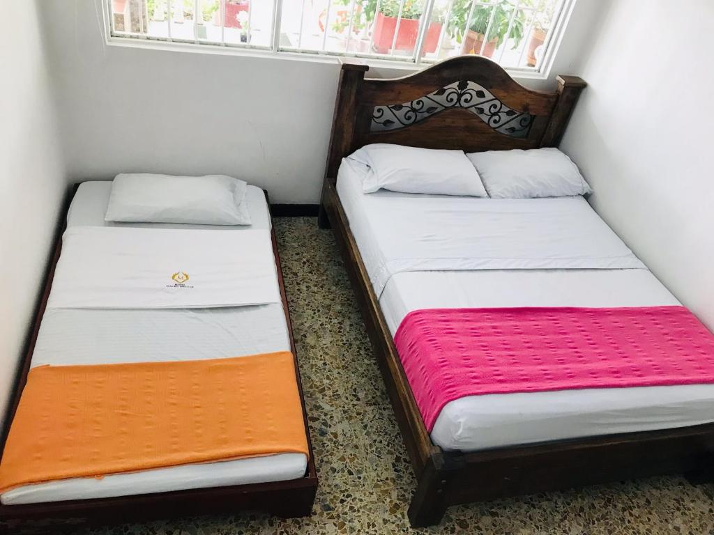 Postel nebo postele na pokoji v ubytování HOTEL MACEO MELGAR