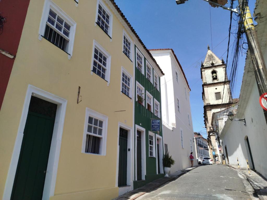 a building with a clock tower on a street at São Francisco Aparts in Salvador