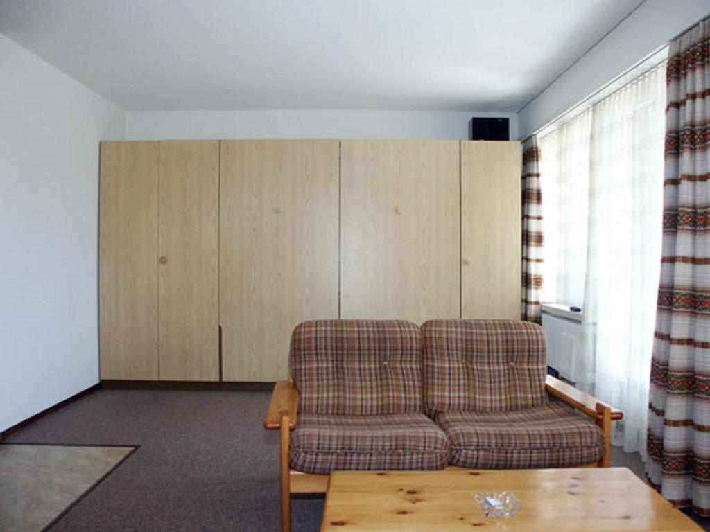 a living room with a couch and a table at Davos Swiss Alps in Davos