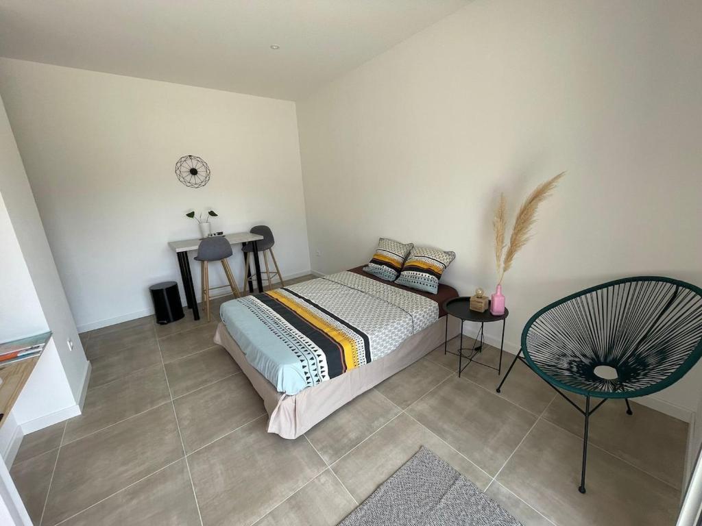 a bedroom with a bed and a clock on the wall at Chez Sam & Nico in Bollène