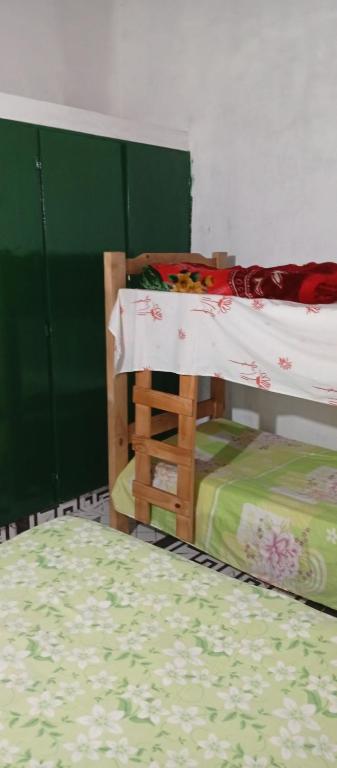a bedroom with two bunk beds and a green wall at Ultra in Ituzaingó