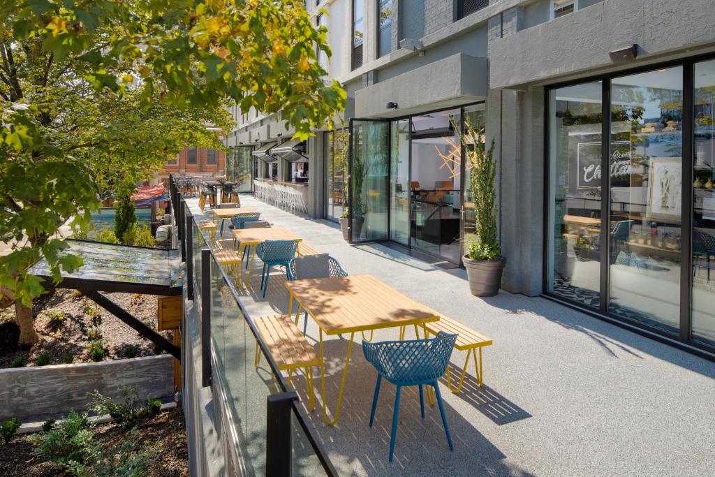 a row of tables and chairs outside of a building at Hotel Indigo Chattanooga - Downtown by IHG in Chattanooga