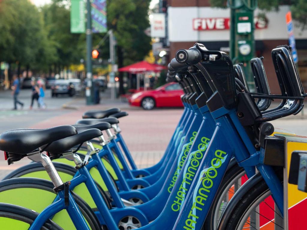 a row of blue bikes parked next to a street at Hotel Indigo Chattanooga - Downtown by IHG in Chattanooga