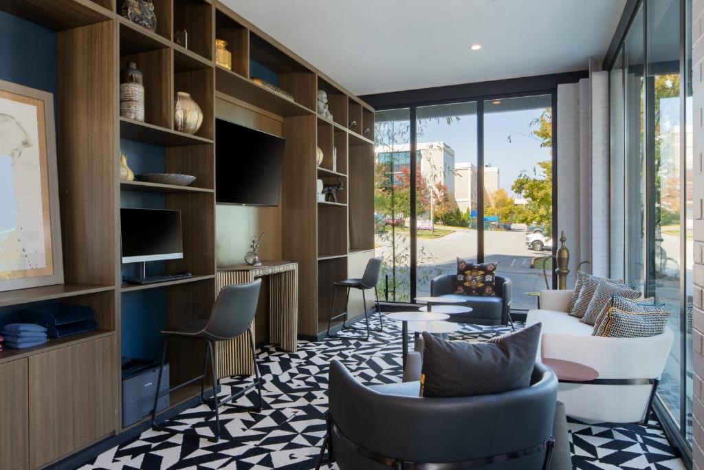 a living room with couches and a table and chairs at Hotel Indigo Chattanooga - Downtown by IHG in Chattanooga