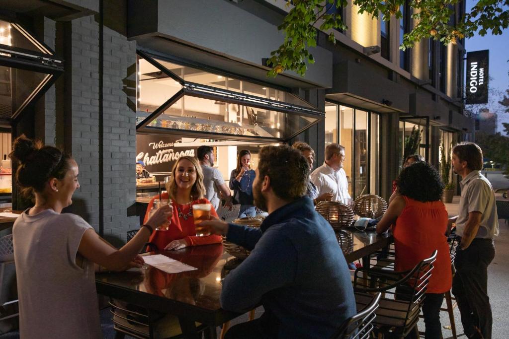 a group of people sitting at a table outside a restaurant at Hotel Indigo Chattanooga - Downtown by IHG in Chattanooga