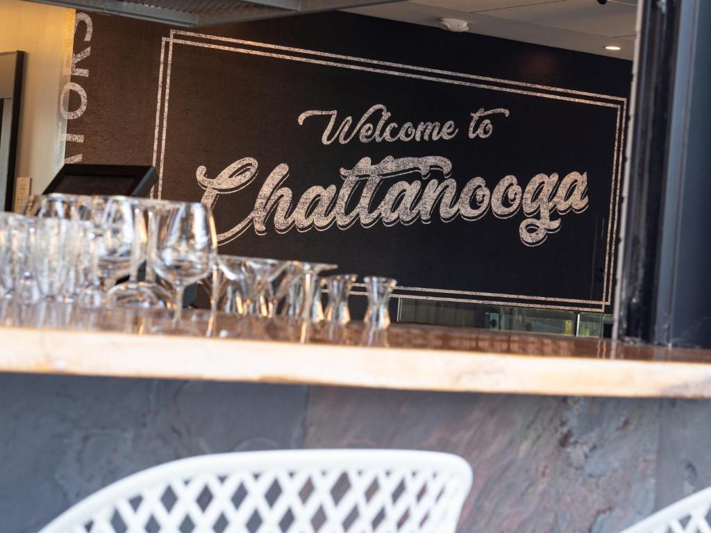 aelcome to chattanooga sign on a counter with glasses at Hotel Indigo Chattanooga - Downtown by IHG in Chattanooga