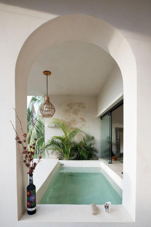 a swimming pool in a house with an archway at Casa Miztli in Brisas de Zicatela