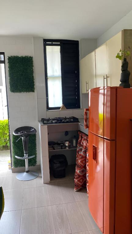 a kitchen with a refrigerator and a stool in it at BORA - Apto 101Tu espacio fuera de casa in Ibagué