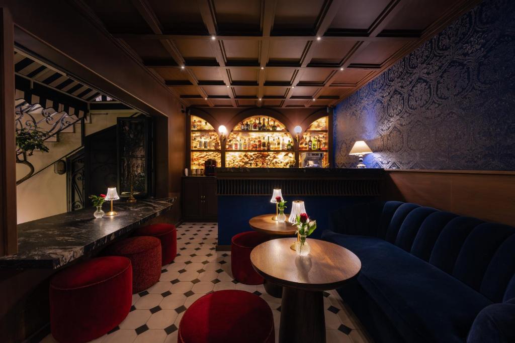 a restaurant with two tables and a blue couch at Villa Ganz Boutique Hotel in Guadalajara