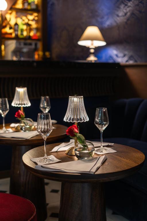 a table with four wine glasses and a flower on it at Villa Ganz Boutique Hotel in Guadalajara