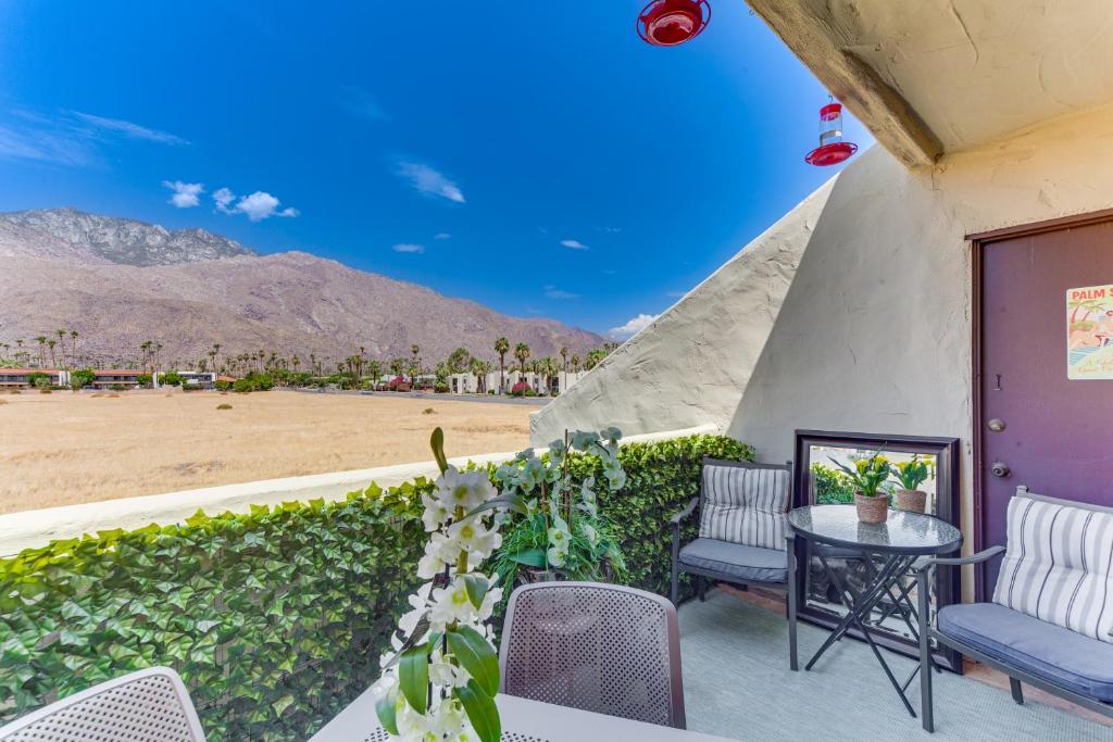 a patio with a table and chairs and a view of the desert at Mtn-View Condo with Pool Access in Palm Springs! in Palm Springs