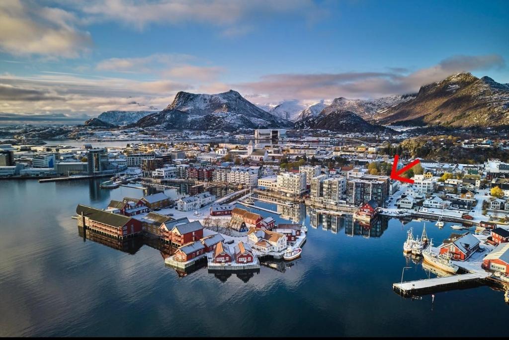 an aerial view of a harbor with boats in the water at Central City Apartment in Svolvær
