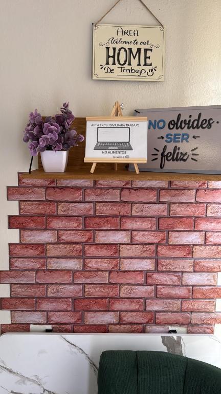 a brick wall with a computer on a shelf at Casa Josefina Allende Nuevo Leon in Allende