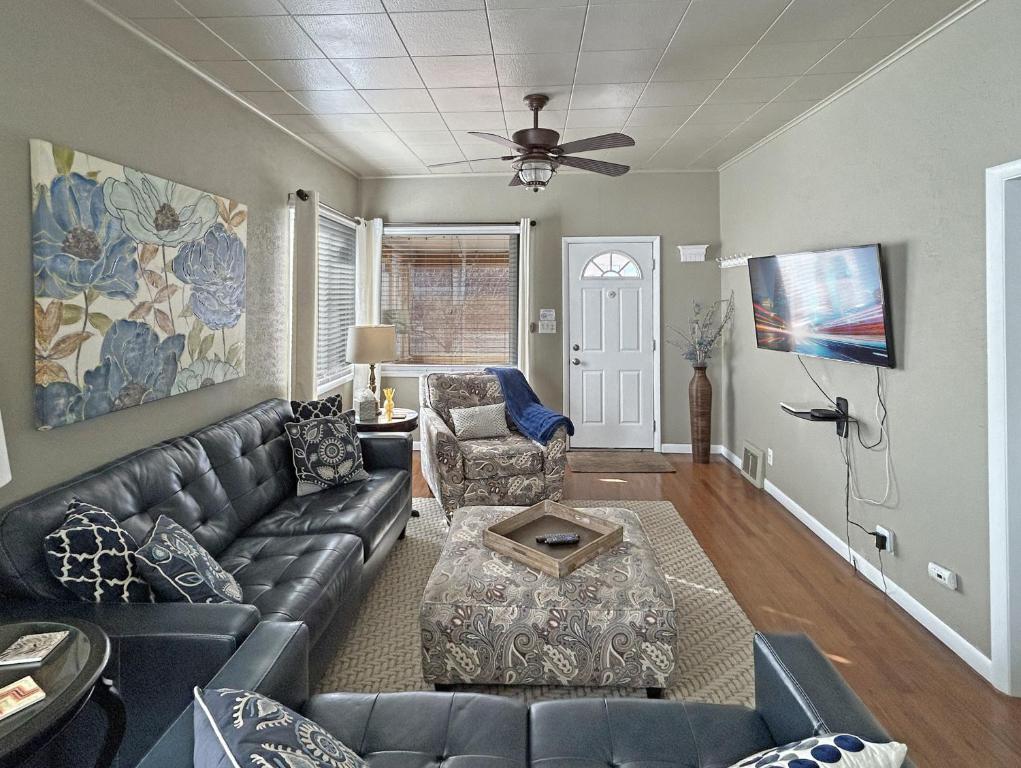 a living room with a leather couch and a table at Home Away From Home home in Grand Junction